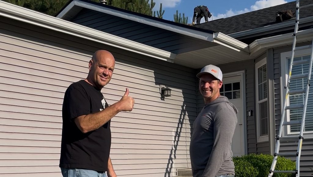 Happy RC Roofing Specialists roof replacement customer smiles at the camera with Josh