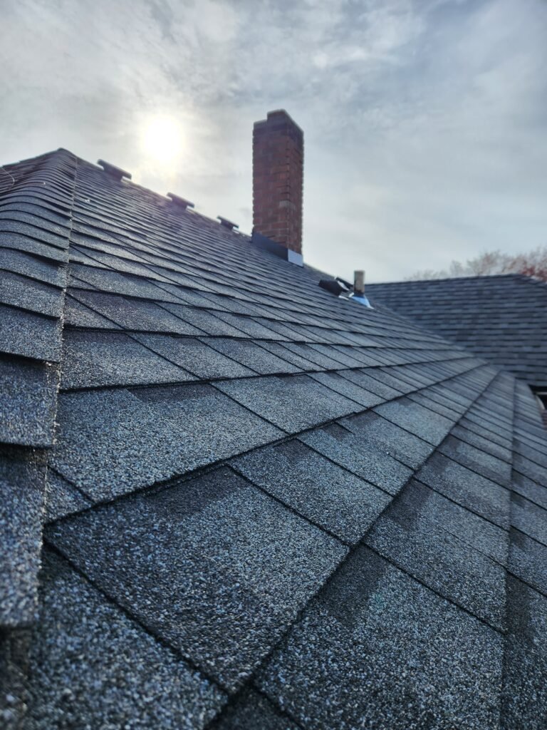 Detailed view of ridge cap and shingle alignment from RC Roofing project