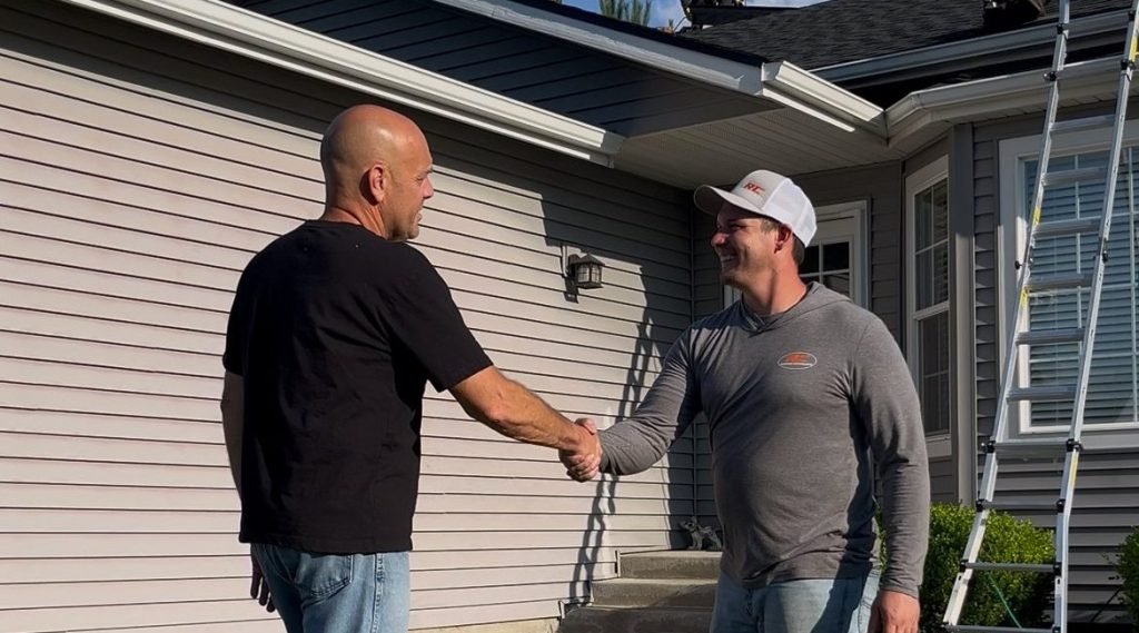 Josh owner of RC Roofing Shaking happy roof replacement customers hand