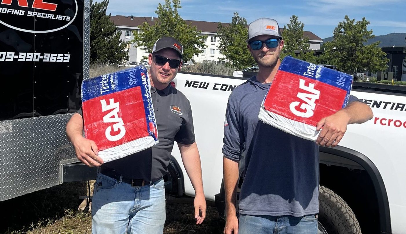 Josh and tanner from RC roofing holding GAF shingles