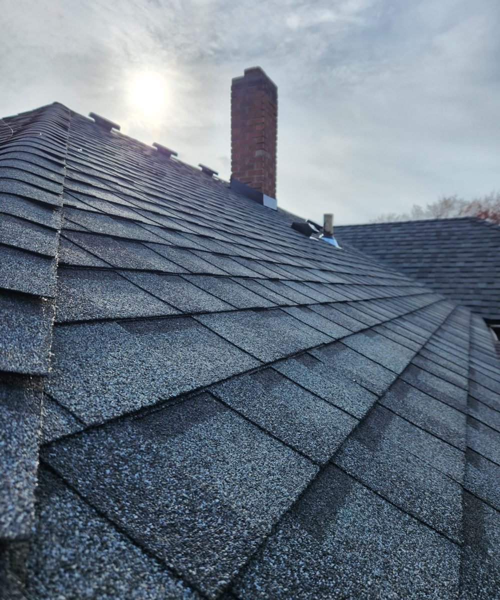 Detailed view of ridge cap and shingle alignment from RC Roofing project
