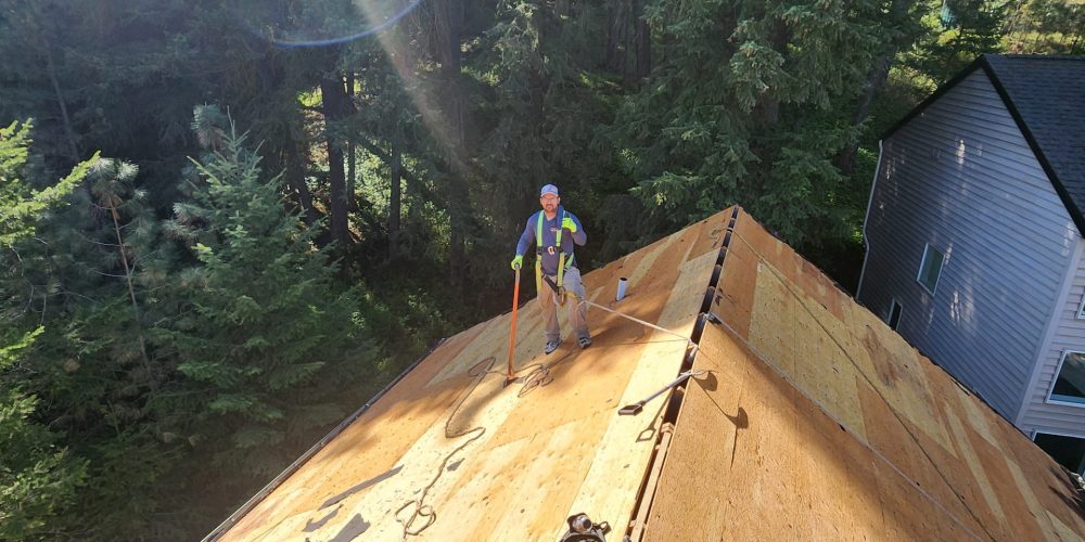 RC Roofing crew installing underlayment on a residential roof